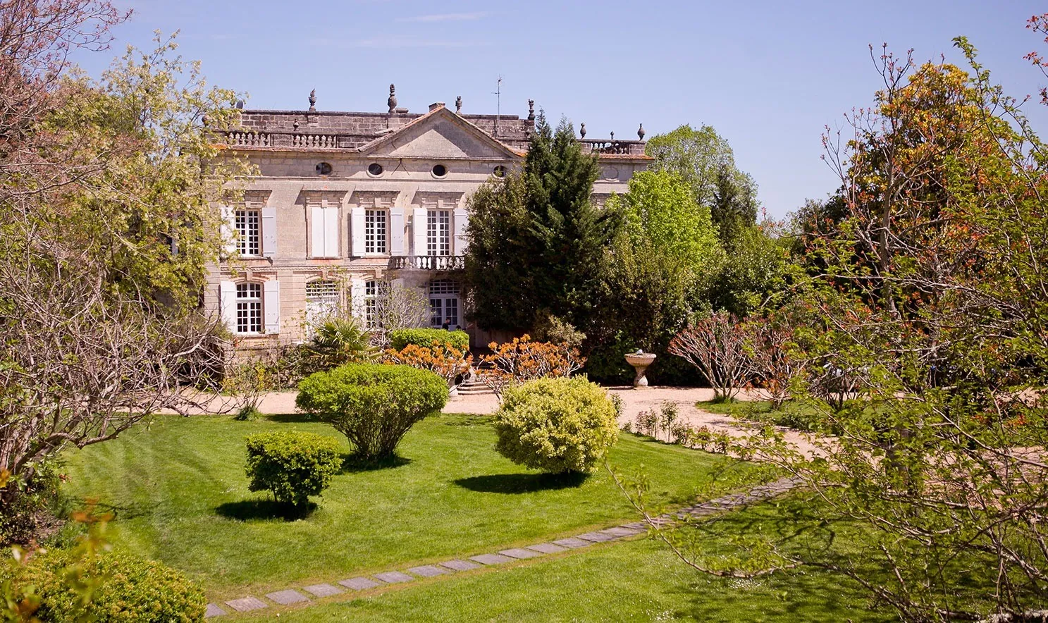 La façade de pierre du Château Latour Ségur, nichée au cœur de son parc arboré